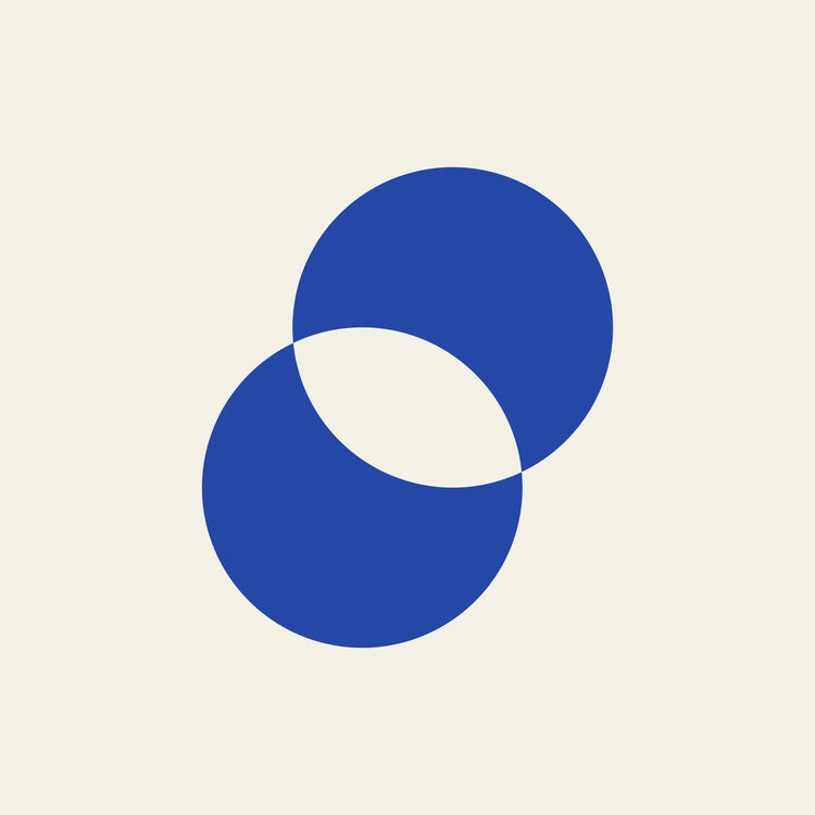 Eclipse overlapping circles paper coaster design from the Blue Shapes collection in cobalt blue and cream