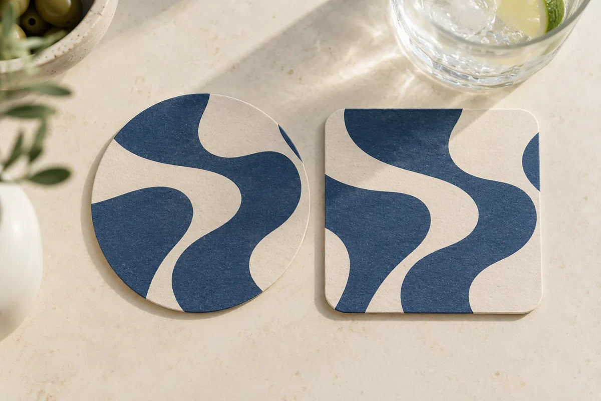 Round and square paper coasters with matching blue abstract artwork