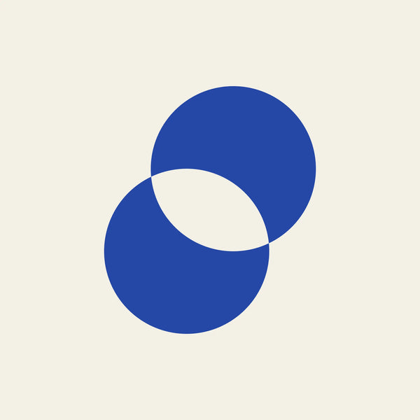Eclipse overlapping circles paper coaster design from the Blue Shapes collection in cobalt blue and cream